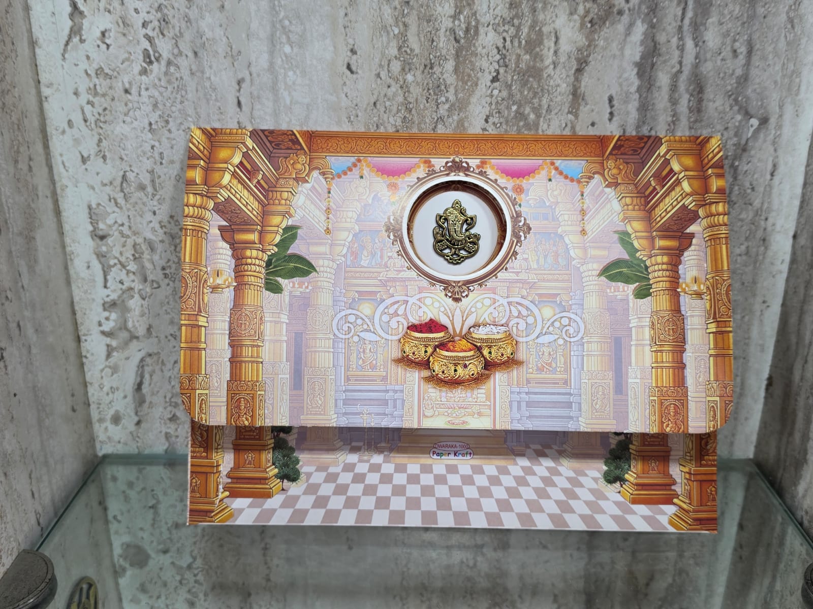 Luxury wedding invitation card featuring a golden Ganesha idol and grand Srinivasa Kalyanam in a pillared mandapam, blending royal tradition with modern elegance. - Image 2
